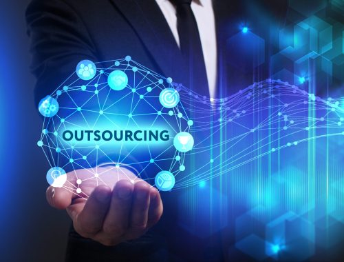 Business, Technology, Internet and network concept. Young businessman working on a virtual screen of the future and sees the inscription: Outsourcing